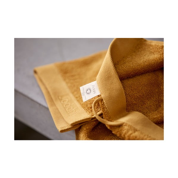 Żółty ręcznik z bawełny frotte Södahl Golden, 100x50 cm-image-1