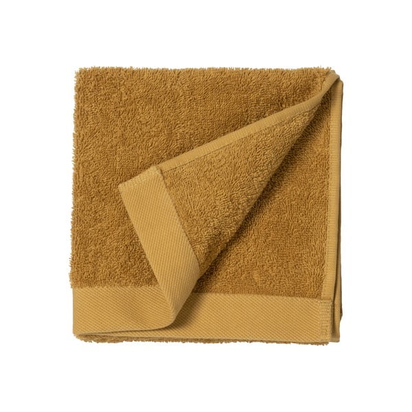 Żółty ręcznik z bawełny frotte Södahl Golden, 100x50 cm